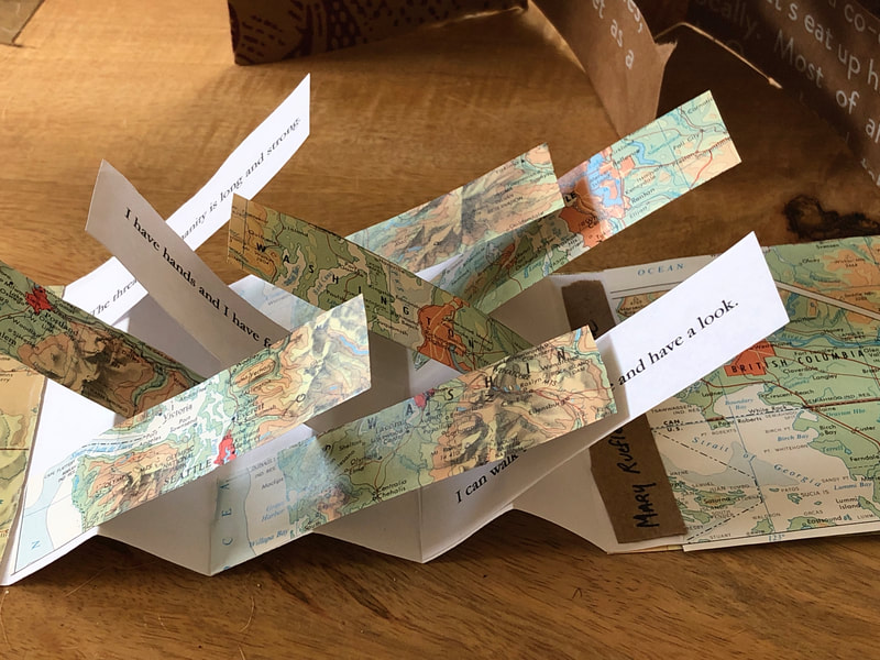 Flag fold book with text and repurposed map pages